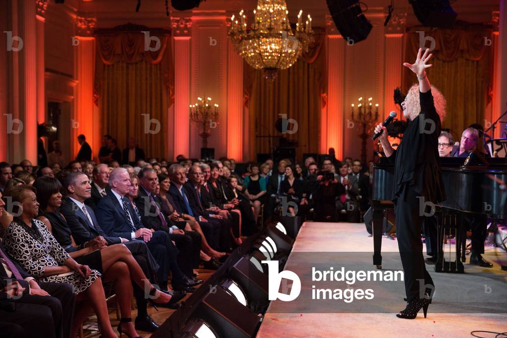 Carole King singing on stage in the White House East Room. President Obama presented King with the 2013 Library of Congress Gershwin Prize for Popular Song. May 22, 2013