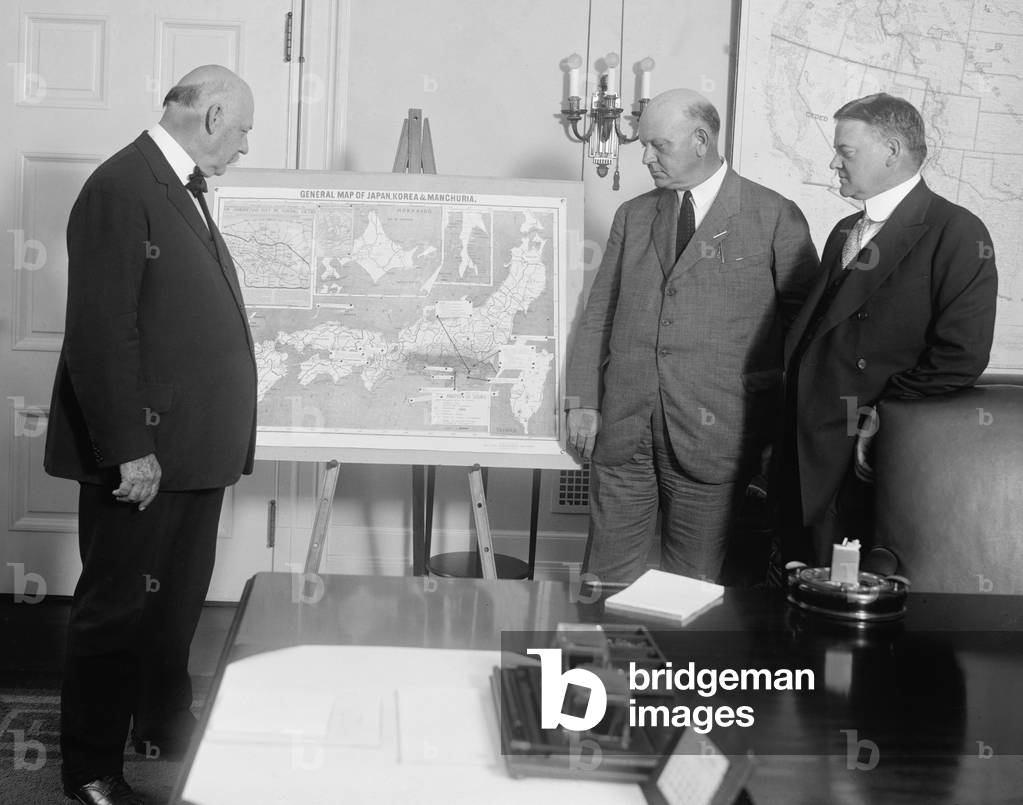 Sec. of War, John Weeks, Sec. of Navy, Edwin Denby, and Sec. of Commerce, Herbert Hoover, study a map of Japan, Korea, and Manchuria. In the early 1920's military strategists were already anticipating future conflict with Japan. Sept. 7, 1923