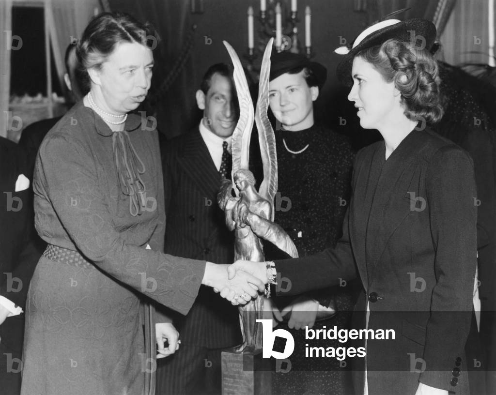 Jacqueline Cochran receives Aviation award. Mrs. Franklin Roosevelt presented to Jacqueline Cochran (right) the trophy of the International League of Aviators and Aviatrix for 1937. April 4, 1937 -