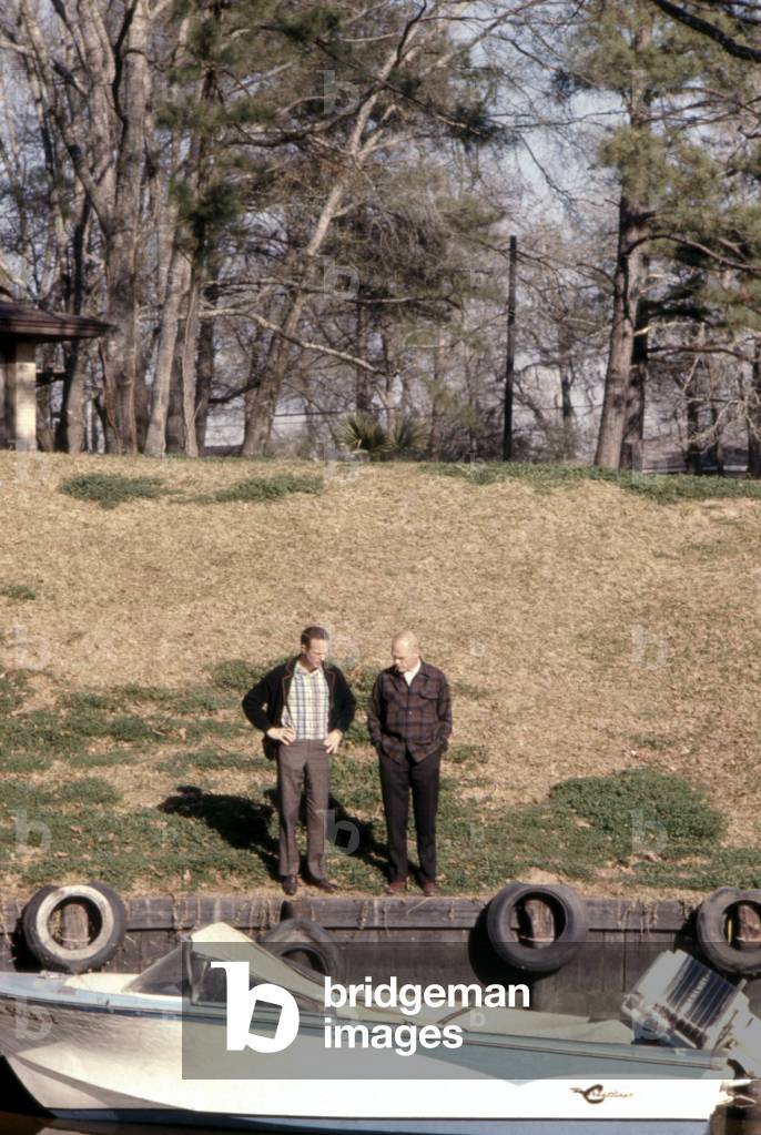 Mercury astronauts John Glenn and Scott Carpenter on the lawn outside of the Glenn's house, Ohio, 1965