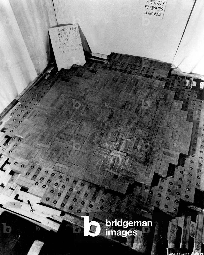 Photograph made during the construction of the Chicago Pile-1 (CP-1), the first nuclear reactor. It was a pile of uranium pellets and graphite blocks, that contained a critical mass of fissile material with control rods