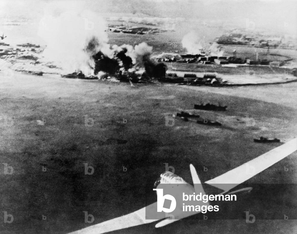 Photograph taken by a Japanese pilot, of the destruction of Pearl Harbor. At lower right is a Japanese bomber. Dec. 7, 1941