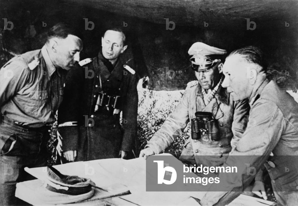 Field Marshal Erwin Rommel confers with his staff on the Libyan front, July 1942. He was fighting the British in the First Battle of El Alamein, July 1-27, 1942, which halted the German advance toward the Alexandria and the Suez Canal