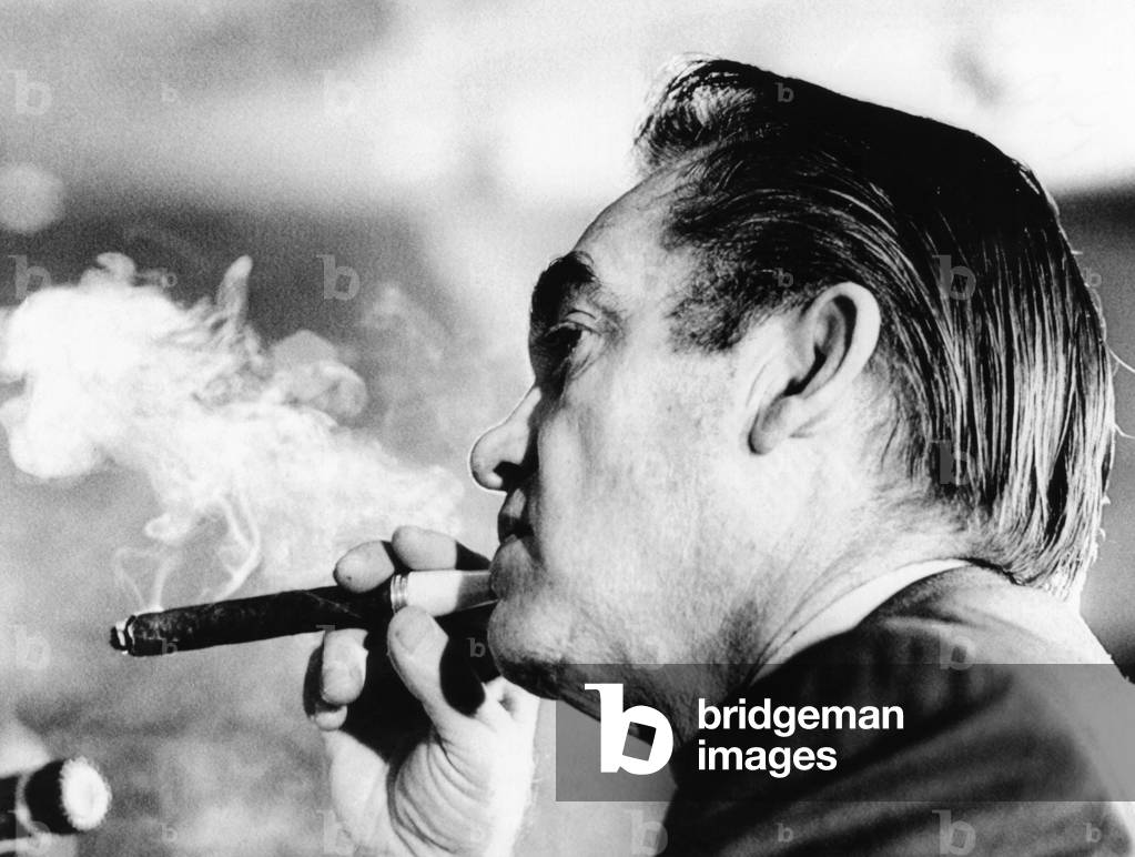 Alabama Gov. George Wallace puffs on a cigar. He was at the National Governors' Conference listening to a speech by Vice President Spiro Agnew. Feb. 23, 1972