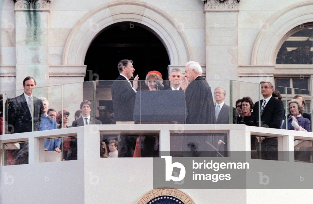 Mrs. Reagan holds the Bible as Ronald Reagan takes the oath of office administered by Chief Justice Warren Berger. Jan 20 1981