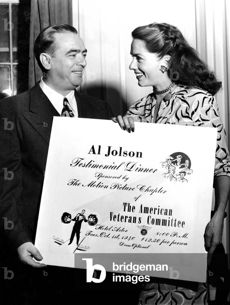 NYC Mayor William O'Dwyer, Jinx Falkenburg, presenting the mayor with an Honorary Ticket to the American Veterans Committee Testimonial Dinner for Al Jolson, New York, NY, 1946