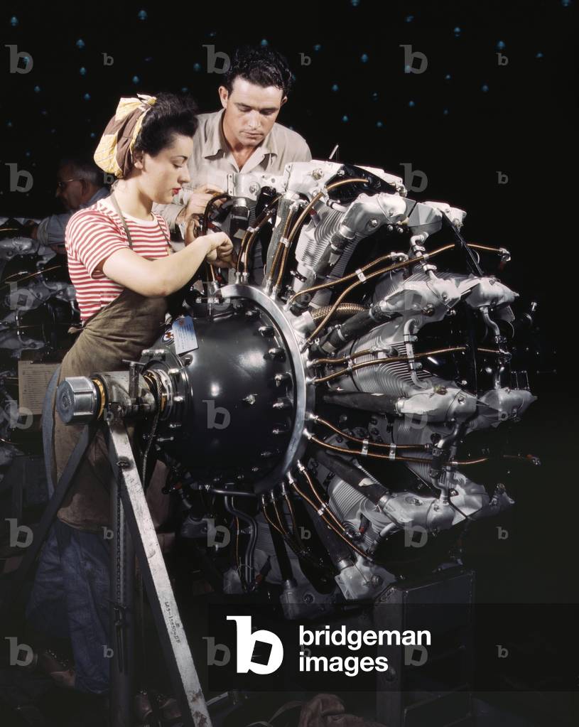 Woman war worker in training as an engine mechanic at Douglas Aircraft Company. Long Beach, California during World War 2, c. 1942-45