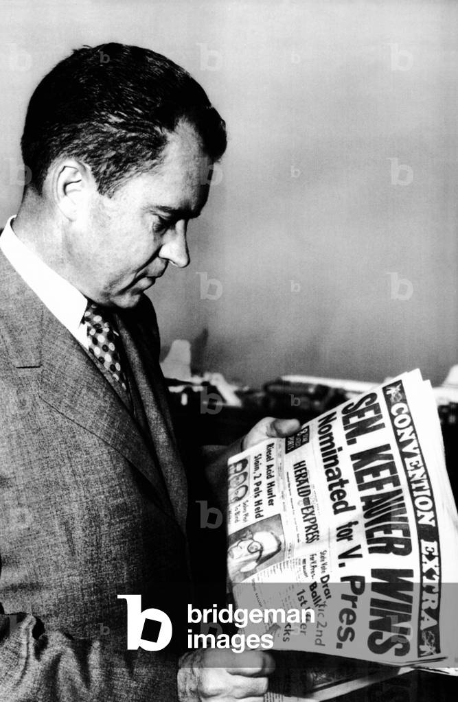 Vice President Richard Nixon reads a headline about Democratic Vice Presidential nominee, Senator Estes Kefauver. Aug. 18, 1956