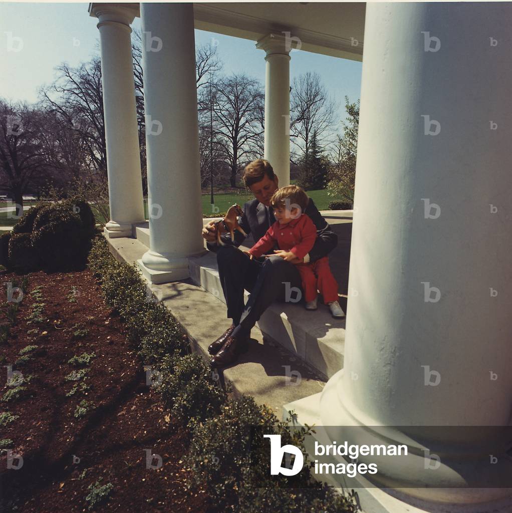 President John Kennedy plays with son John Jr. at the West Wing of the White House. 1962
