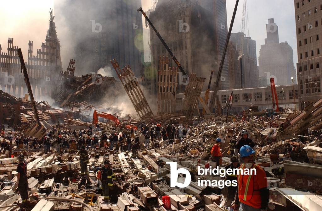 Rescue workers and firefighters in the wreckage at the World Trade Center two days after the 9-11 terrorist attacks on Spt. 13 2001. View toward the Southwest area of WTC site