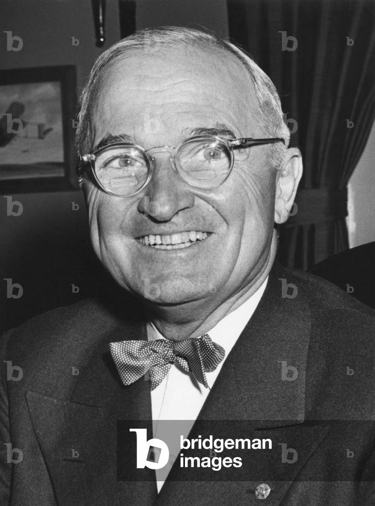 Harry Truman starting his 6th year as U.S. President with a smile. Photo taken at Truman's White House office on April 12, 1950.