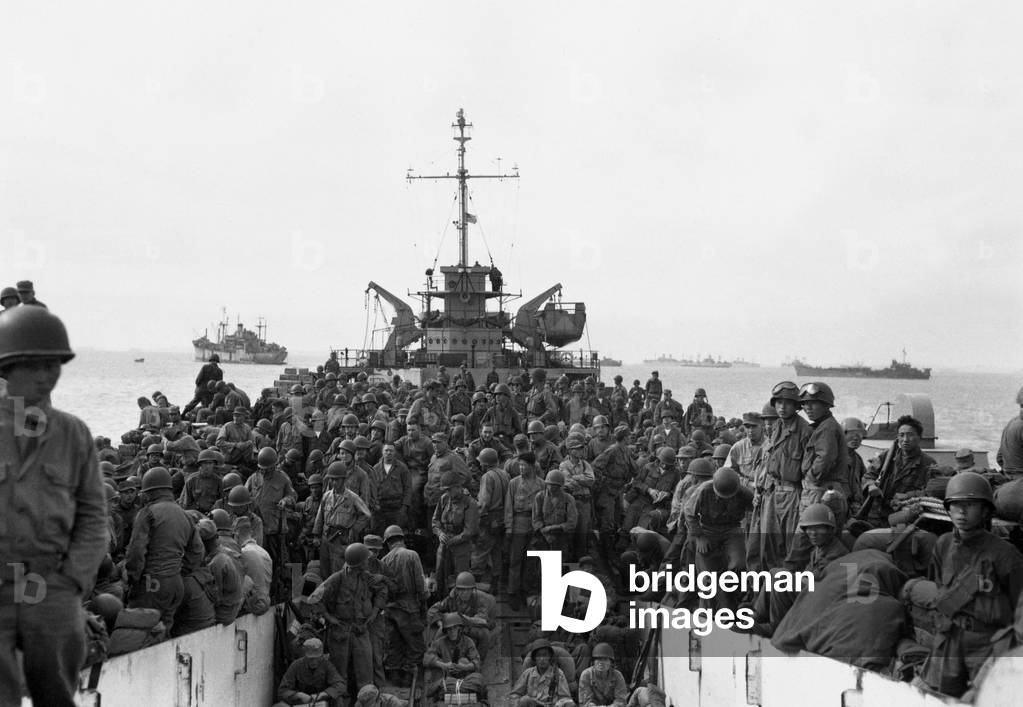 Troops of the 31st Infantry Regiment land at Inchon Harbor, Korea, aboard LST's. They landed in large numbers on Sept. 18, 1950, three days after the first landings, as forces built up to advance toward Seoul. Korean War, 1950-53