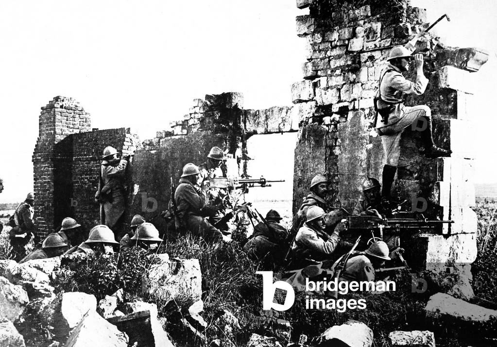 World War I French troopers under General Gouraud, driving back the Germans with their machine guns, from the shelter of cathedral ruins. 1918
