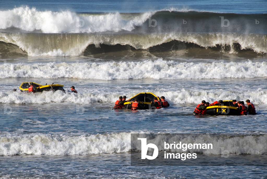 US military personnel in six-month SEAL training Underwater Demolition course in a surf passage exercise. Oct. 27 2010