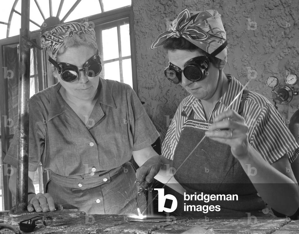 Two Daytona Beach, Florida, housewives welding in an Aircraft construction class during World War II. Both have sons in the military. April 1942