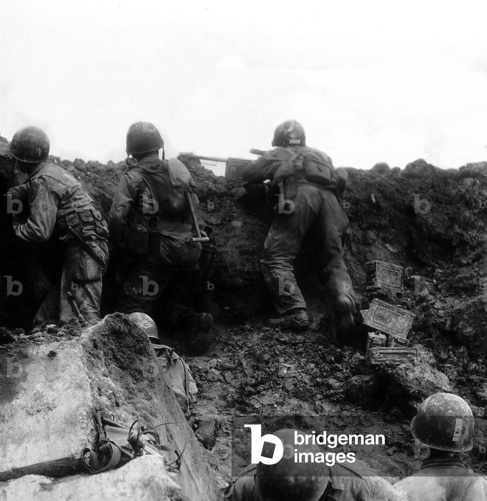 U.S. Rangers firing from a bunker between Pointe du Hoc and Omaha Beach. June 7, 1944. D-Day plus 1, Normandy, France, World War 2