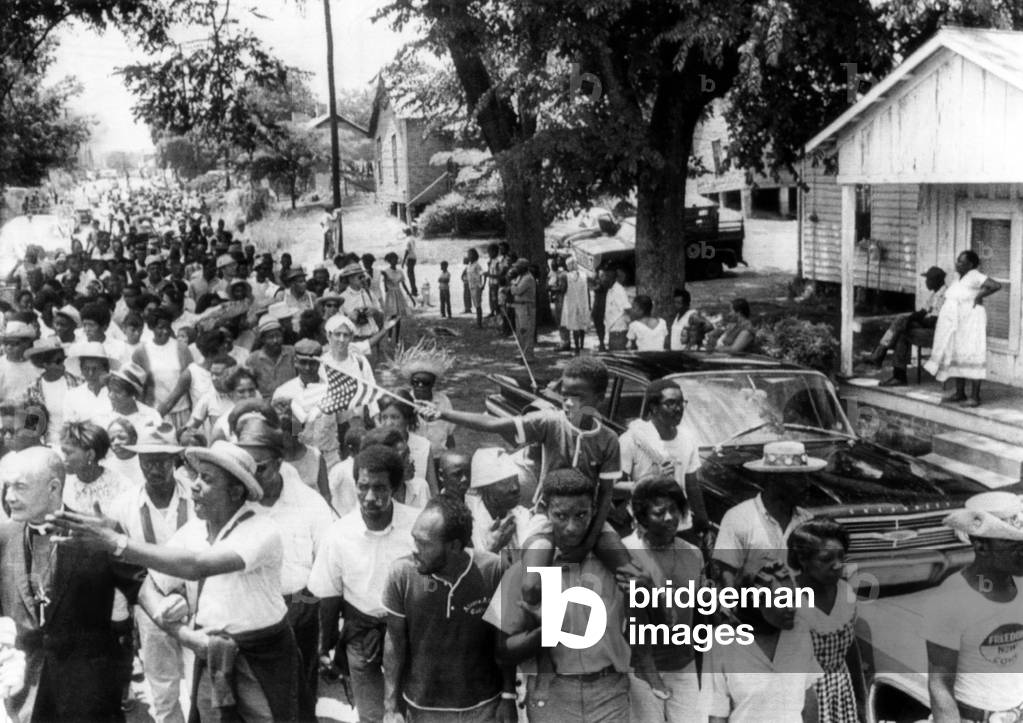 'Mississippi Freedom Marches' enter the small town of Granada, Mississippi. Floyd McKissick (front left with outstretched arm), CORE national chairman, calls for all to join the march, 1966