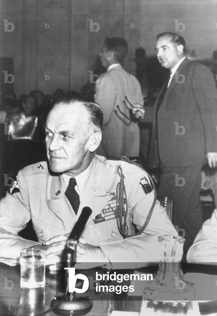 Brig. Gen. Ralph Zwicker prepares to resume testimony before the Senate Censure Committee. Sept. 3, 1954. Sen. Joseph McCarthy was accused of abusing the highly decorated World War II D-Day Commander. Sen. Joseph McCarthy is at right background
