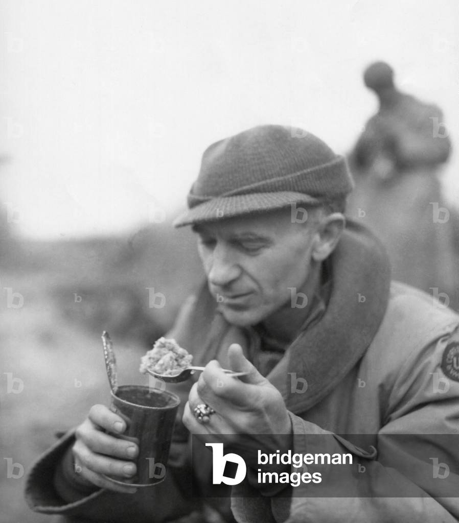Ernie Pyle, war correspondent, eating his 'C' rations. First Army, Anzio Beachhead, Italy, March 18, 1944