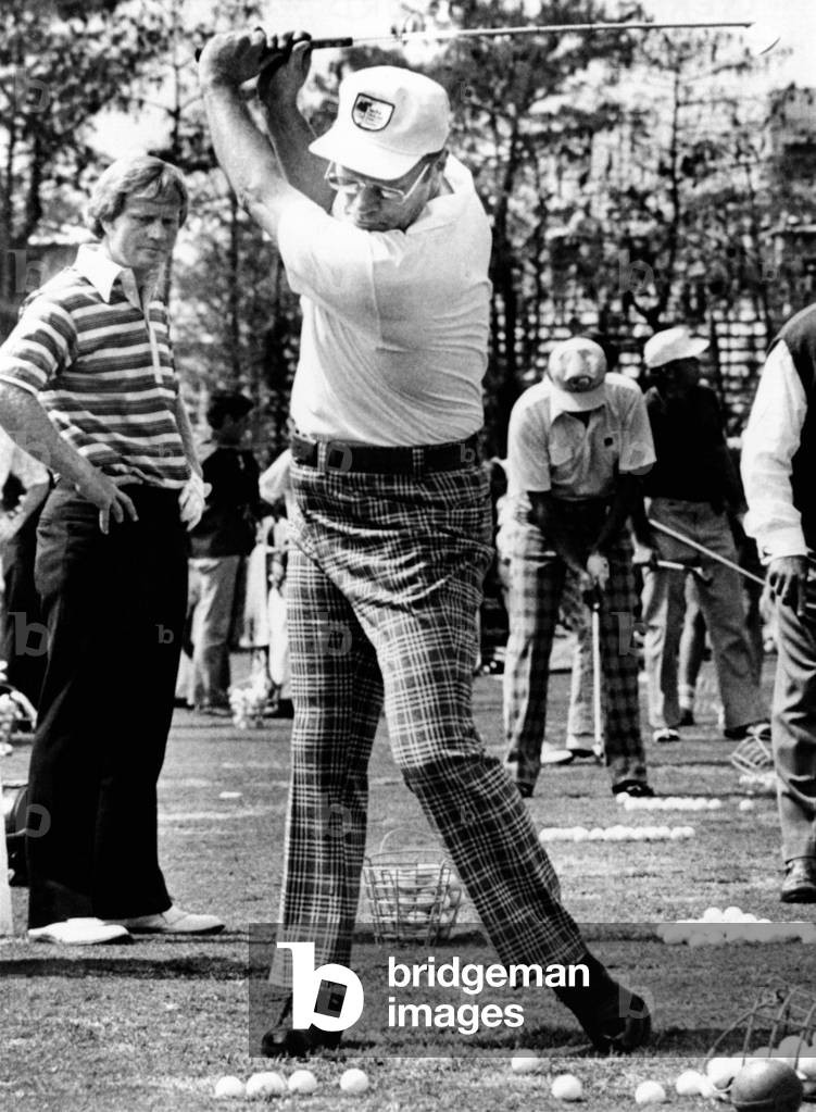 Jack Nicklaus (L) watches President Ford's golf swing at the Inverrary Classic in Lauderhill, Florida. Feb. 2 , 1975