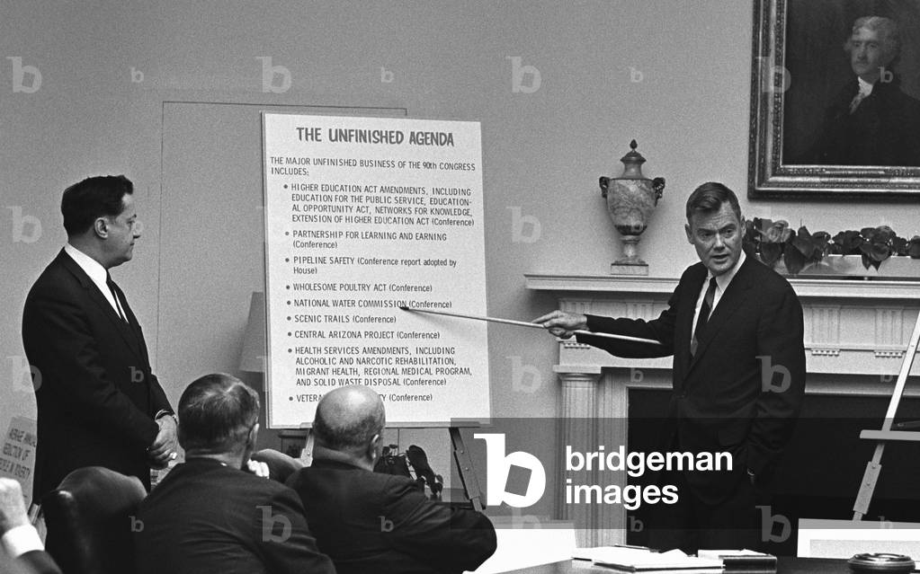 LBJ's Great Society programs. With less than six months until the end of the LBJ presidency, Harold 'Barefoot' Sanders, Legislative Counsel to the President, displays the 'Unfinished Agenda' at a Cabinet Meeting. July 31, 1968