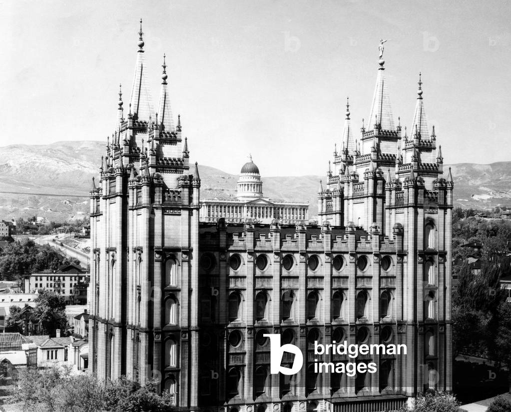 The Salt Lake City Mormon Temple with Utah's state Capitol Building in the background, 1930.
