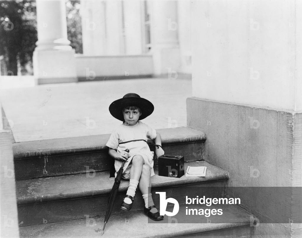 Waiting for the President, a young girl sits on the White House steps with a camera by her side waiting for President Warren G. Harding, photograph by Mrs. W. Tarkington, Washington DC, June 29, 1922