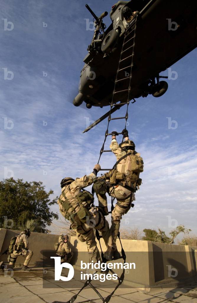 US Air Force Rescue Squadron climb into a helicopter near the Baghdad International Airport Iraq. on Dec. 20 2004