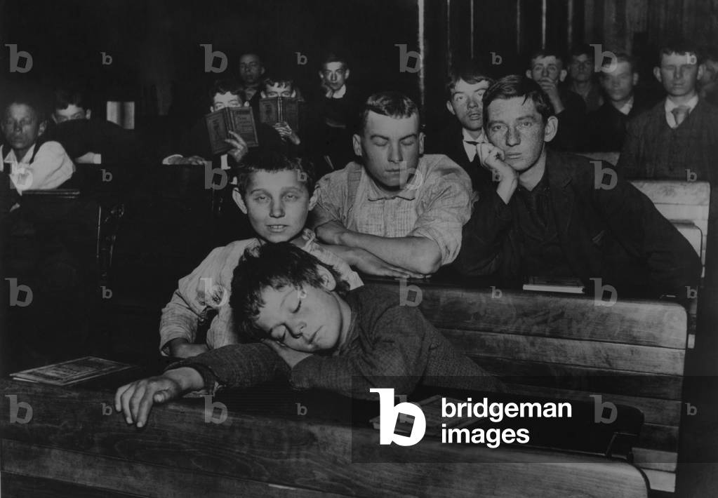 Boys and teenagers attend night school in the Seventh Avenue Lodging House, which was home for a couple hundred 'Street Arabs,' who worked during the day and no longer lived with their families. 1900 photograph by Jacob Riis