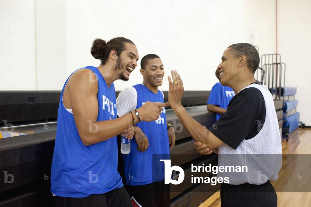 President Barack Obama jokes with Chicago Bulls players Joakim Noah and Derrick Rose. The President played basketball with friends college and professional basketball players before an audience that included wounded warriors and White House mentees at Fort McNair in Washington D.C. August 8 2010.,