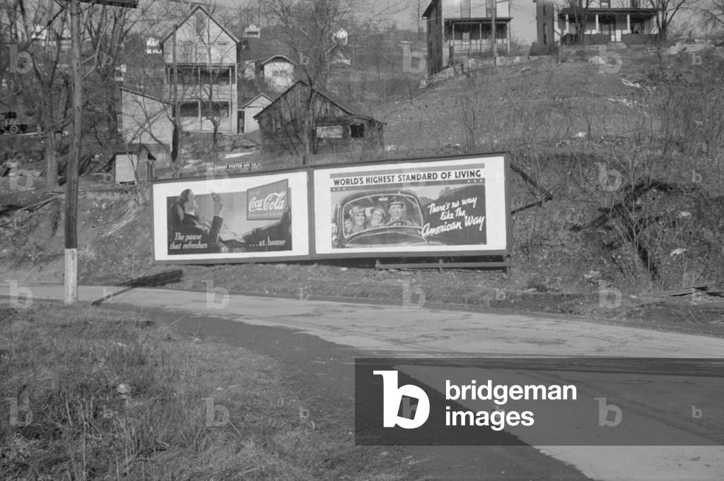 Duel billboard near Kingwood West Virginia advertising Coca-Cola and a politically motivated pro-business sign celebrating America's 'World's Highest Standard of Living'. Feb. 1937