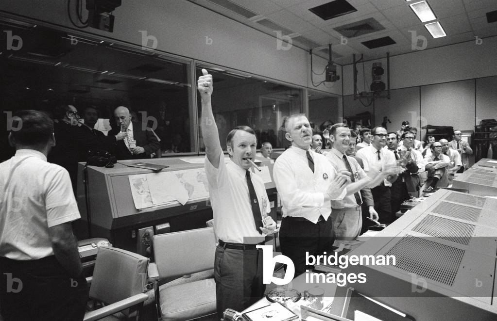 Apollo 13 Flight Directors applaud the successful splashdown of the Command Module. In the background Robert Gilruth, Director, Manned Spacecraft Center and Chris Kraft, Deputy Director, light up cigars. April 17, 1970