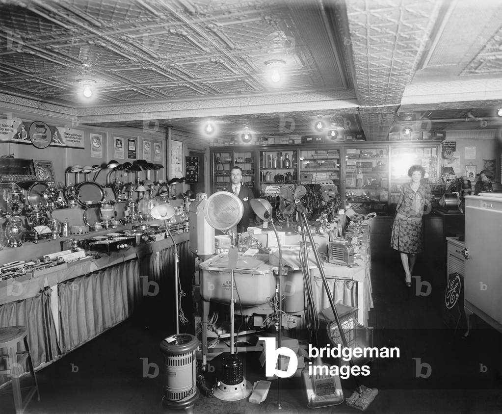 1920's showroom of Schneider Electric Store in Washington, D.C. Among the electric consumer products on display include: lamps, fans, space heaters, floor cleaners, clothes washers, refrigerators, toy trains, percolators, hotplates, toasters, irons and hair wavers. Westinghouse and General Electric brands are prominent