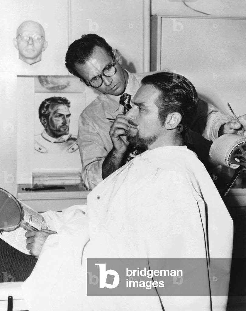 Makeup artist Ben Nye working on actor Douglas Fairbanks, Jr. c. 1940s
