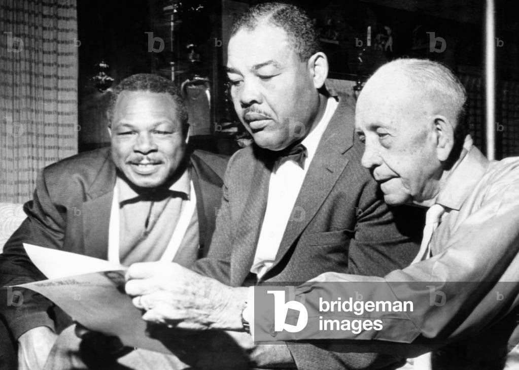 Conferring on the possibility of an Archie Moore vs. Gene Fuller.