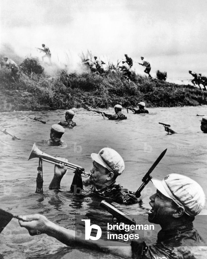 Chinese Communist soldiers cross a river during training. The bugle was used to communicate commands to troops. Aug. 1966