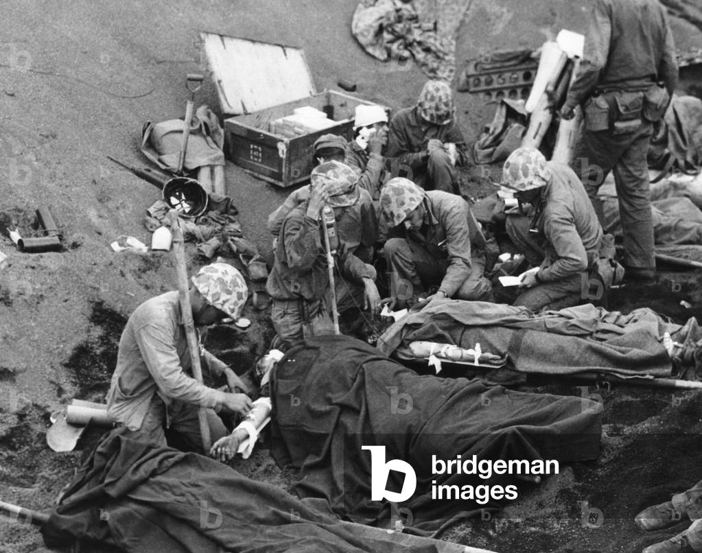 Navy doctors and corpsmen treat seriously wounded Marines on Iwo Jima. Feb. 19-March 26, 1945, during World War 2