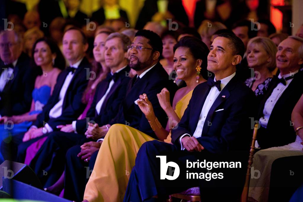 President and Michelle Obama listen as Gladys Knight performs during the Governors Dinner in the White House East Room. Feb. 27 2011. Michelle wears a yellow one-shoulder gown by Prabul Gurung.,