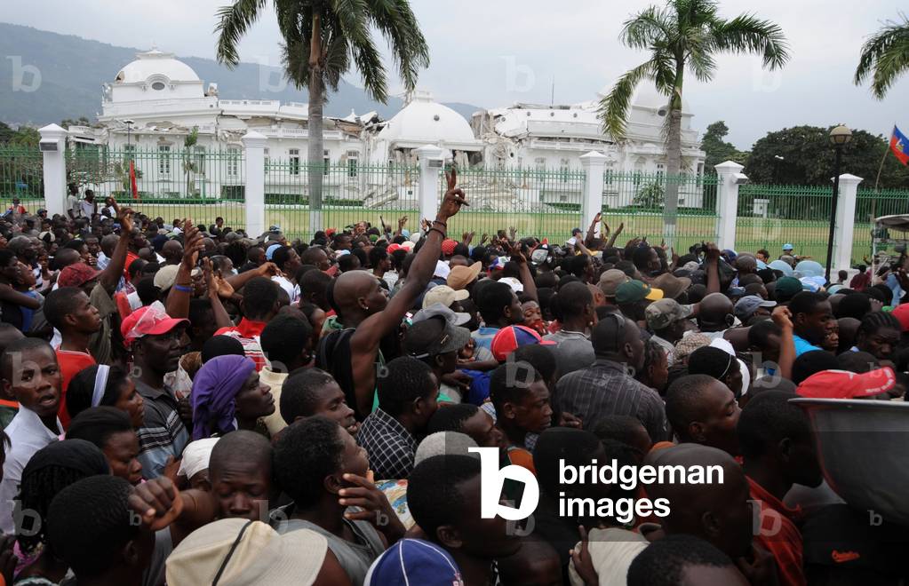 Haitians gathers for food distribution in front of the destroyed Presidential Palace in Port au Prince Haiti on Jan. 25 2010. A 7.0-magnitude earthquake on January 12 2010
