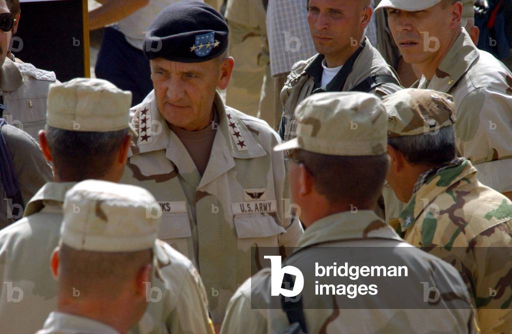 Army General Tommy R. Franks center Commander of coalition forces greets soldiers while visiting at Bagram Air Base Afghanistan on Aug. 24 2002., Photo by:Everett Collection