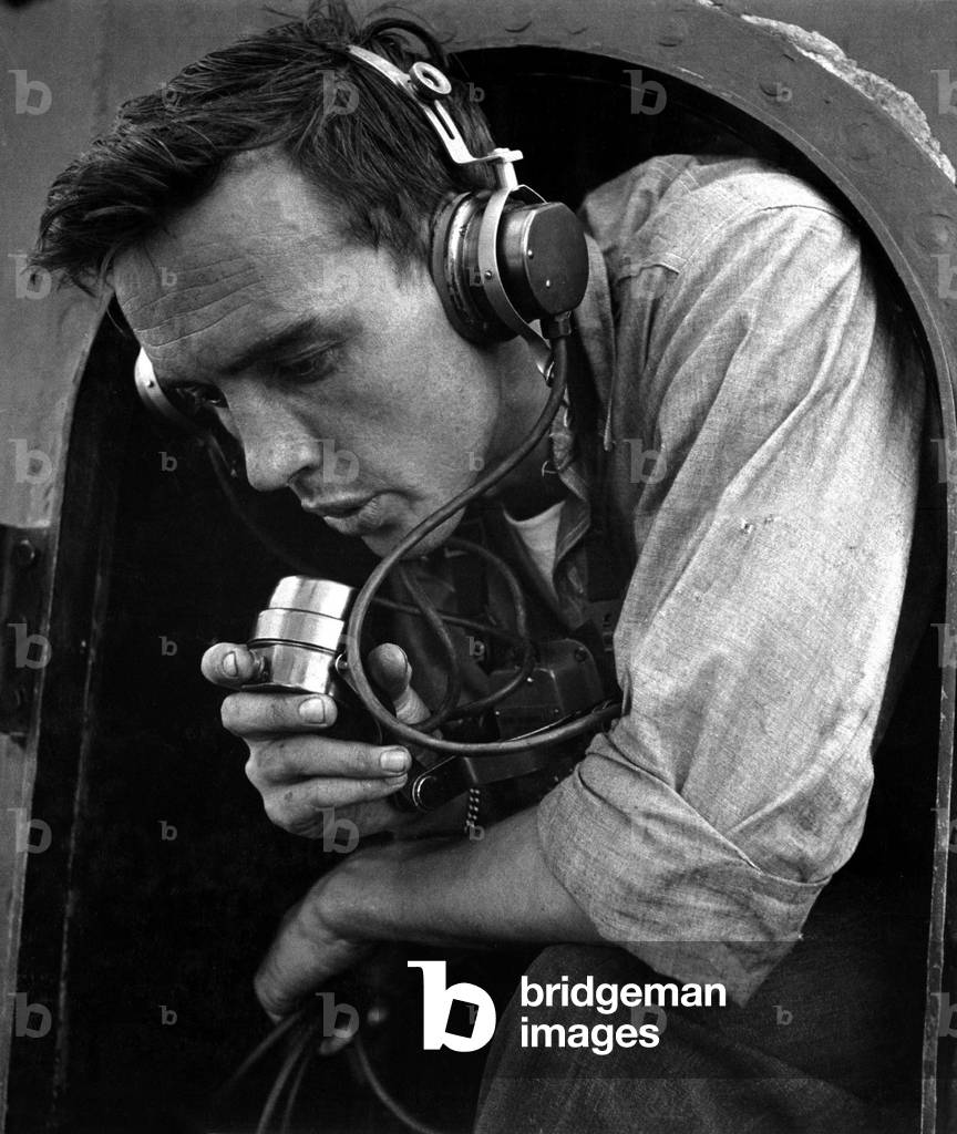 Submariner relaying commands to 20mm gun crew in training exercise. Photo taken on bridge of U.S. submarine at New London, Conn. World War 2, August 1943