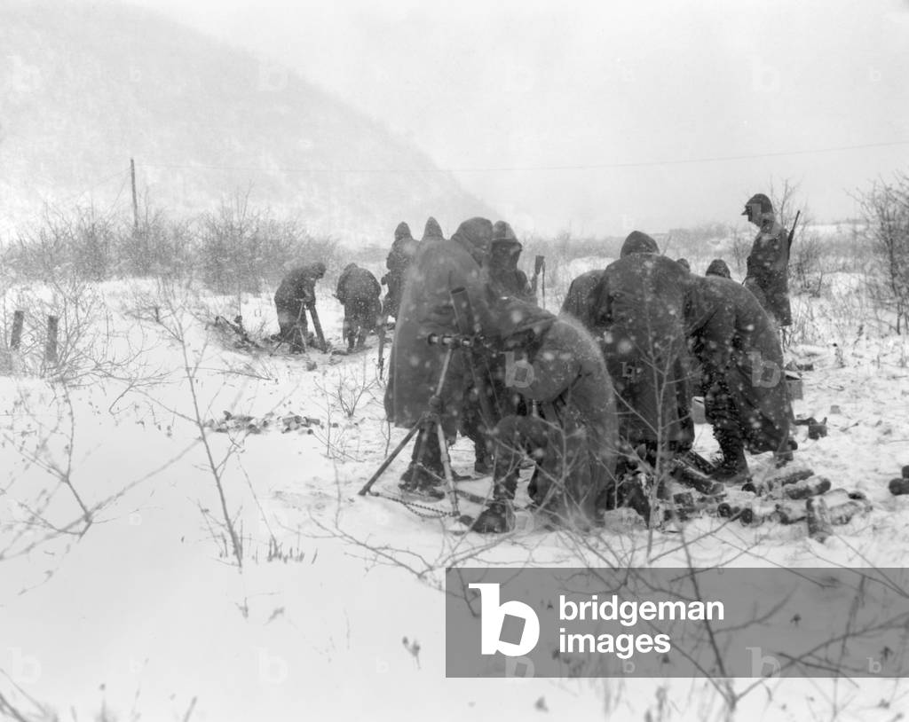 Marines fire mortars at Chinese positions on the road from Kotori to Hungnam in Dec. 1950. U.S. troops fought to clear Chinese from the high ridges to prevent their firing on the withdrawing convoy. Korean War, 1950-53