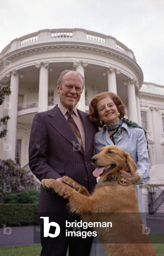 President Gerald Ford and wife Betty pose with Liberty, their pet golden retriever. South Lawn of the White House. May 9, 1975. Photo by David Hume Kennerly