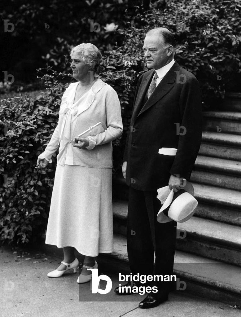 President Herbert Hoover and first lady, Lou Henry Hoover, pose for the annual presidential year photo in the garden of the White House, June 15, 1932.