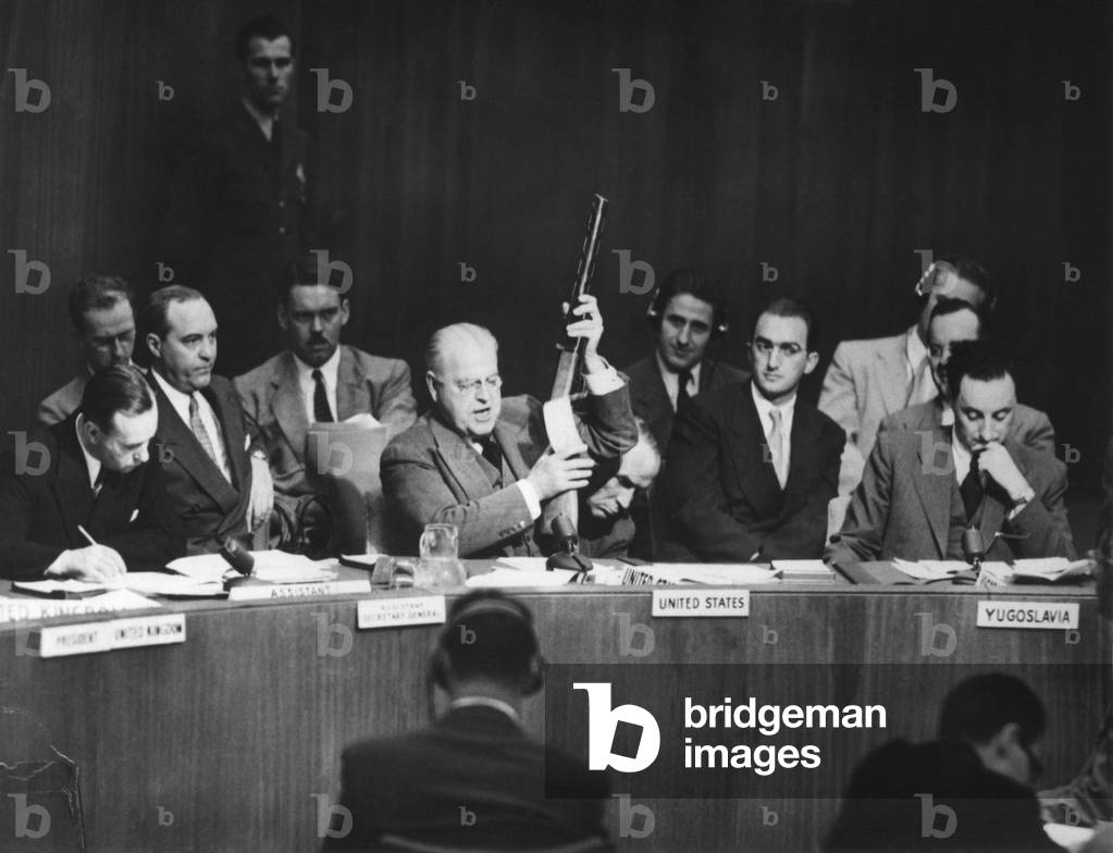 Warren Austin, U.S. delegate to UN, charged that Russia was delivering arms to North Koreans. He held Russian-made submachine gun dated 1950, captured by American troops in July 1950. Sept. 19, 1951. Korean War, 1950-53