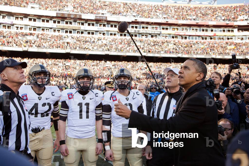 President Barack Obama performs the coin toss before the annual Army vs. Navy football game. Landover, Md., Saturday, Dec. 10, 2011