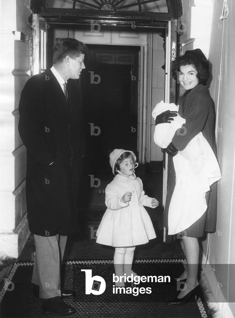 Kennedy Family Returns from Palm Beach, Florida on Feb. 4, 1961. President John Kennedy; Caroline Kennedy; Jacqueline Kennedy holding John Kennedy, Jr. at the South entrance, White House, Washington, D.C.