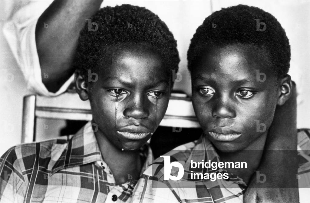 Two young men in South Africa, living under apartheid, by Peter Magubane.