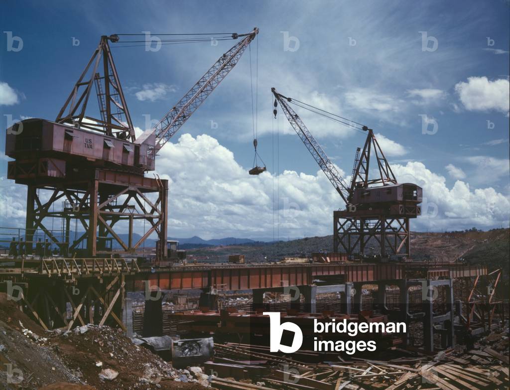 Massive cranes on a steel superstructure during the construction of Douglas Dam, a Tennessee Valley Authority public works project. June 1942