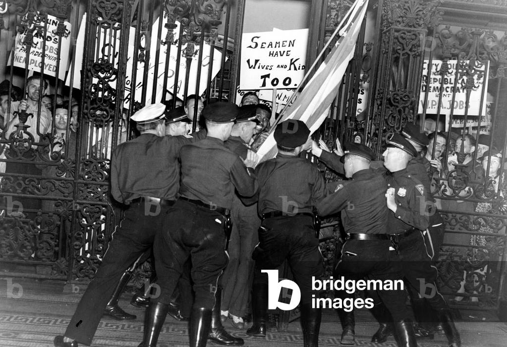 Policemen struggle to hold back more than 1,000 workers who stormed City Hall in Philadelphia, PA, 7/14/38.
